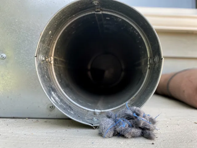 Plantation Dryer Vent Cleaning technician using specialized equipment to clear severe dryer vent blockage in Plantation